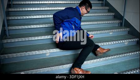 Construction Worker Injured On Stairs After Slip And Fall Accident. Stock Photo