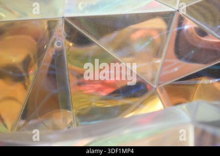 Abstract shiny reflective geometric pattern background with vibrant colorful light refraction creates psychedelic visual effect and optical illusion s Stock Photo