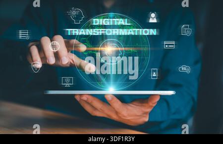 Digital transformation concept. Man holding a tablet displaying a glowing globe surrounded by tech icons: data, cloud, security, and AI, representing Stock Photo