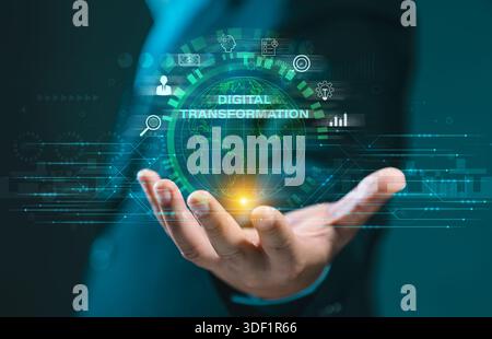 Hand holding a glowing global network sphere with "DIGITAL TRANSFORMATION" text and business icons. Represents innovation, technology adoption, and gl Stock Photo