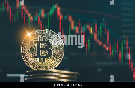 A shiny gold Bitcoin coin stacked on other coins, set against a dark background with red and green candlestick charts illustrating a volatile cryptocu Stock Photo