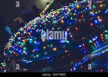 Rome, italy 9 january 2025: decorated car illuminating the dark street with bright, multicolored christmas lights, creating a festive and celebratory Stock Photo