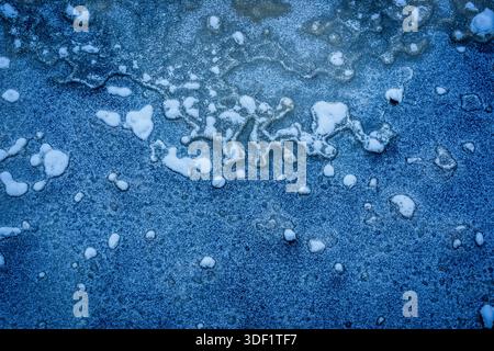 Selective focus photo. Texture on ice. Frozen Riga city canal. Stock Photo