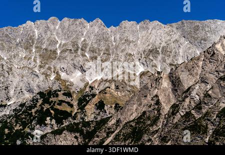 Rugged mountain peaks under a clear blue sky. Stock Photo
