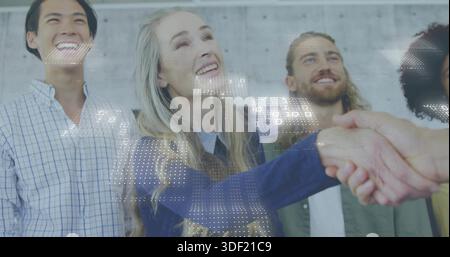 Reaching mature woman shaking hand in front of concrete wall, blue sweater, digital overlay Stock Photo
