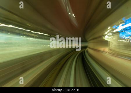 View of blurred motion through the tunnel, lines of light streaking past in a mesmerizing dance of speed and color, Tokyo, Tokyo, Japan. Stock Photo