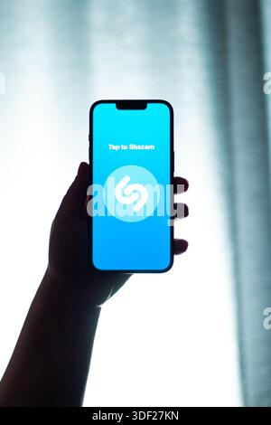 Kaliningrad, Russia - 12.11.2025. Smartphone screen in woman hands displaying logotype of popular application for music searching Shazam. Music songs Stock Photo