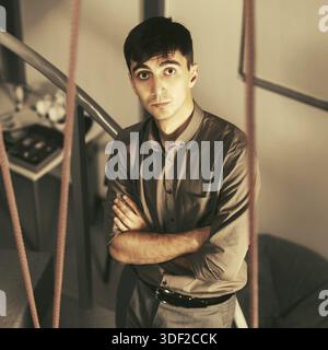 Young handsome business man standing on the steps in office Stock Photo