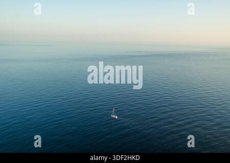 White sailboat on deep blue Mediterranean Sea near Mallorca Stock Photo