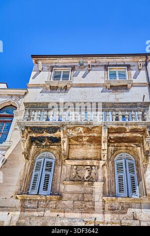 Building Facade of very old stone houses, many with wooden shutters and arched windows, UNESCO  World Heritage site of Split, Croatia, Europe Stock Photo