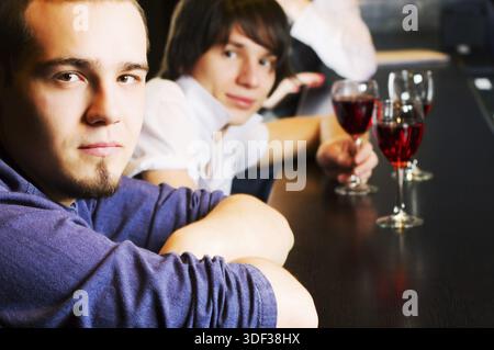 Young men relaxing at a bar counter Stock Photo