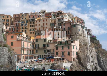 Colorful coastal village built on steep cliffs above the sea. Traditional houses, rocky shoreline and Mediterranean atmosphere create a classic travel Stock Photo