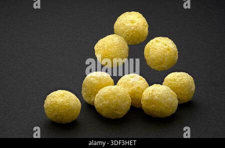 Falling corn balls isolated on black background with copy space, full depth of field Stock Photo