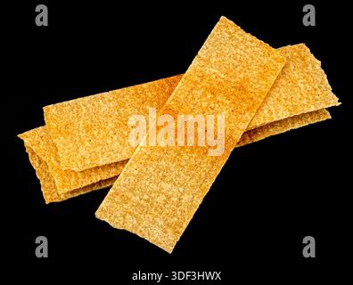 Long chips isolated on black background, rectangular mashed potato snacks, package design element Stock Photo