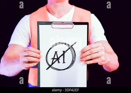 Two hands grasping clipboard with hand-sketched prohibition symbol over AI letters Stock Photo