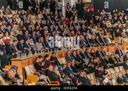 Prominent figures from politics and culture watch the Şeb-i Arus ceremony from the VIP box at the Mevlana Kültür Merkezi in Karatay, Konya, Turkey, a venue that holds up to 3,000 people. Şeb-i Arus is the annual festival marking the death anniversary (17 December) of the mystic poet Rumi (1207–1273), founder of the Mevlevi order, celebrated as a spiritual union with God. Stock Photo