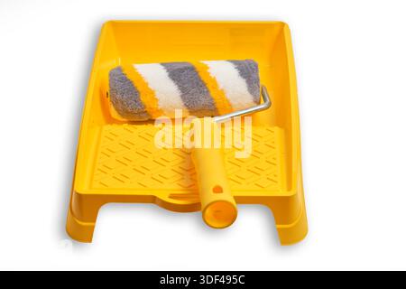 Paint roller with yellow handle and yellow paint tray on white background Stock Photo