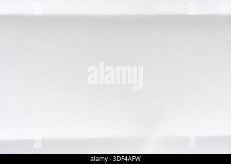 Minimalistic white paper texture with horizontal folded lines for background or design inspiration. Stock Photo