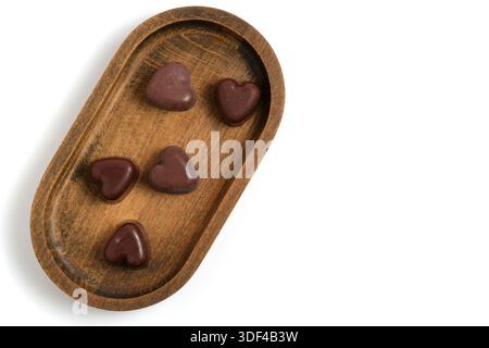 Chocolate hearts in wooden tray isolated on white background Stock Photo