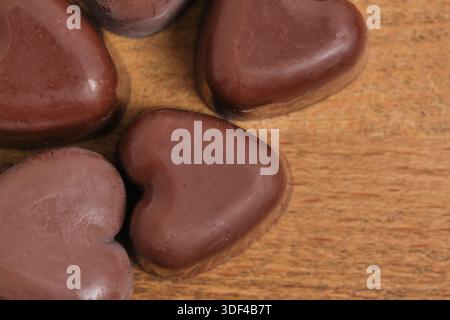 Chocolate hearts on wooden background. Valentine's Day background Stock Photo