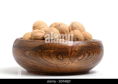 Walnuts in wooden bowl isolated on white background. Close up Stock Photo