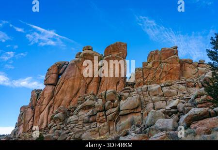 Towering granite spires and rugged rock formations at Vedauwoo Recreation Area in Wyoming beneath a vivid blue sky. Stock Photo