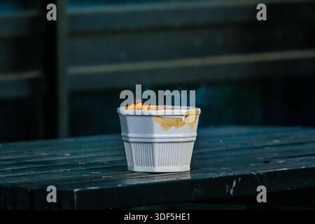 Fire rising from an ashtray on a table Stock Photo