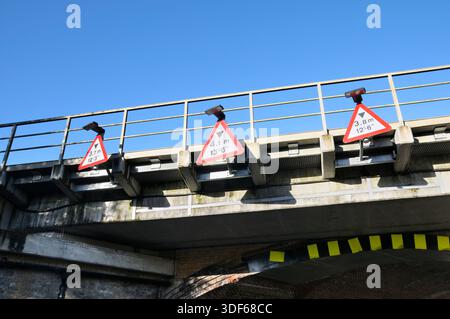 Red triangle warning road signs on bridge tunnel showing height limit restrictions for vehicle use in metres (Metric), feet and inches (Imperial) UK Stock Photo
