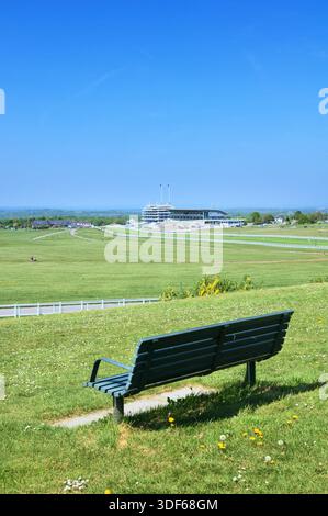 Bench with a view on The Mound at Tattenham Corner overlooking famous Epsom Downs racecourse and Grandstand, Home of The Derby, Surrey, England, UK Stock Photo