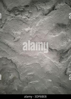 Close-up of rough stone wall texture with natural plastered surface. Ideal as architectural background for design, construction, renovation Stock Photo