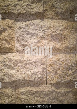 Granite stone wall texture with rough cut blocks and natural surface. Ideal architectural background for construction, exterior design, renovation Stock Photo
