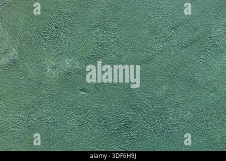 Turquoise Green Painted Wall with Rough Textured Plaster Surface Abstract Background Stock Photo