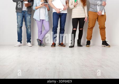 Young people using gadgets, students, technology Stock Photo