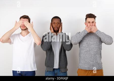 Three wise monkey scene showed by young men in casua Stock Photo