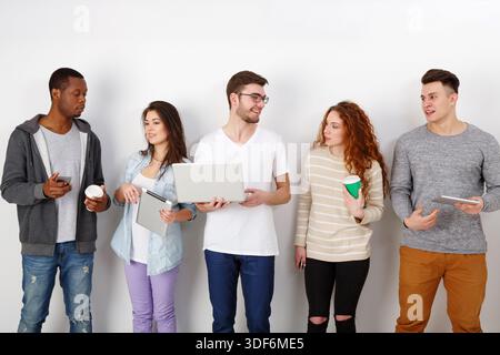 Young people using gadgets, students, technology Stock Photo