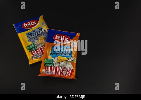 Lviv Ukraine 12.08.2025 Two bags contain popcorn with distinct flavors. They are placed on a dark surface. The snack packaging displays labels and ima Stock Photo