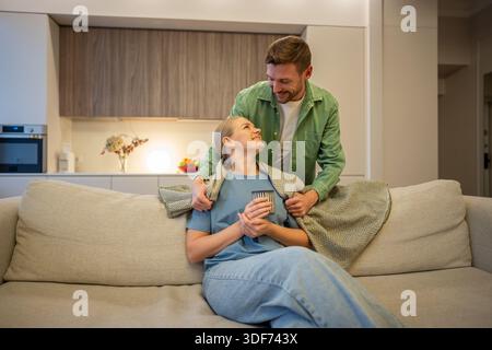 Care and love in modern relationships, man and woman partners spending time together at home. Stock Photo