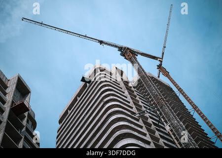 Tall modern building being built from concrete Stock Photo