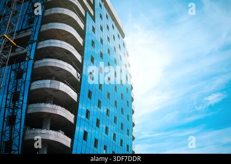 Tall modern building being built from concrete Stock Photo