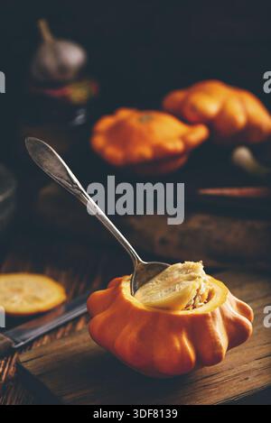 Preparing yellow pattypan squash for stuffing with minced meat Stock Photo