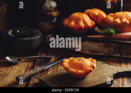 Yellow pattypan squash on cutting board Stock Photo