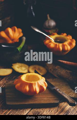 Preparing yellow pattypan squash for stuffing with minced meat Stock Photo