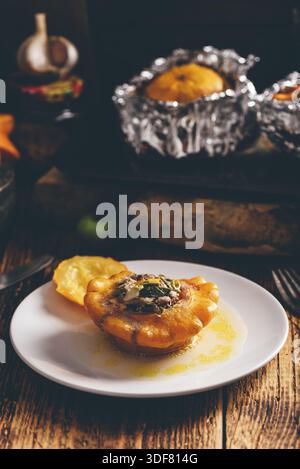 Yellow pattypan squash stuffed with minced meat on white plate Stock Photo