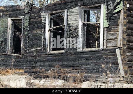 Empty window Burnt old wooden house Stock Photo
