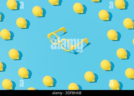 Creative abstract summer lemon and glasses pattern flat lay on pastel blue background minimalism Stock Photo