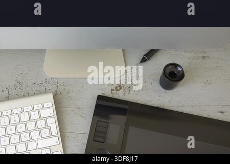Top View of Computer, Keyboard and Graphic Tablet on Wooden Table Stock Photo