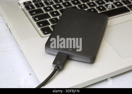 External Hard Disk Over Laptop Keyboard Stock Photo