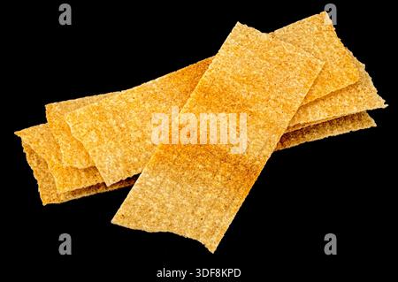 Long chips isolated on black background, rectangular mashed potato snacks, package design element Stock Photo
