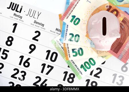 Piggy bank with euro banknotes on a July calendar, top view, concept of travel planning and saving money by booking early Stock Photo