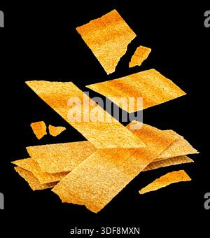 Falling long chips isolated on black background, rectangular mashed potato snacks, package design element Stock Photo
